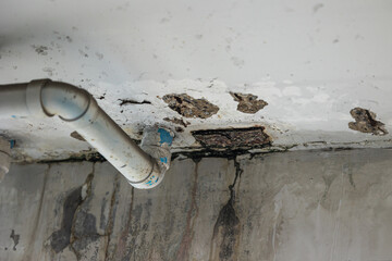 sewer pipe leak bad old plumbing water leakage inside the concrete wall rusty damaged building...