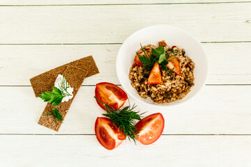 bulgur with vegetables, spices and herbs. rye bread with cottage cheese and herbs for breakfast. vegan food