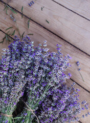 Floral postcard with few bunches of lavender on background of wooden board, top view. Bouquets of violet lavender flowers, preparing lavender for season of drying aromatic herbs. - 626363335