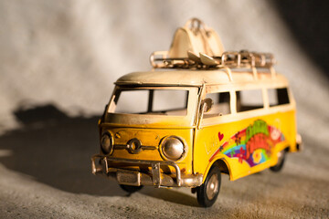 Small hippie yellow van toy. Vacation, traveling concept