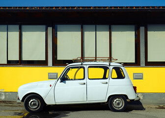 Vintage white car, retro style parked on the street in Province of Como, Italy