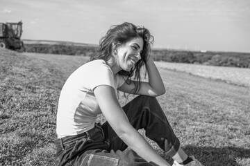 portrait d'une jeune femme assise dans un champs