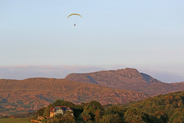 Paramotor pilot flying in the hills of Wales