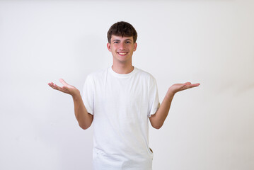 Young caucasian man over isolated white background raising both hands