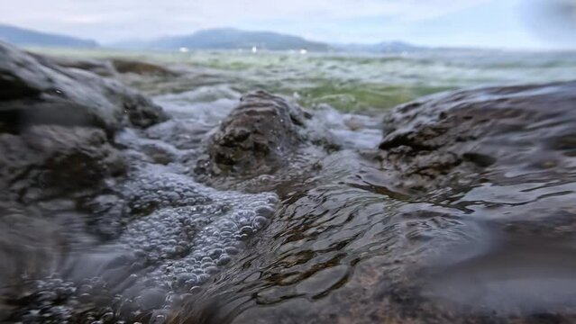 Splash of the waves between the rocks in slow motion