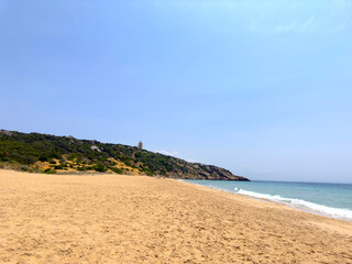 Faro de Camarinal, lighthouse on a cliff and the wonderful sandy beach with the blue turquoise Atlantic Ocean, Playa Los Alemanes, Atlanterra, Andalusia, Spain