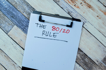 Concept of The 80/20 rule write on paperwork isolated on Wooden Table.