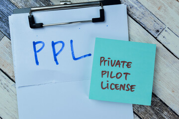 Concept of PPL - Private Pilot License write on sticky notes isolated on Wooden Table.