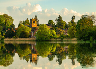Fototapeta na wymiar Town of Ellesmere in Shropshire with reflection view from across the Mere to the Church