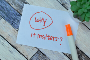 Concept of Why it Matters? write on sticky notes isolated on Wooden Table.