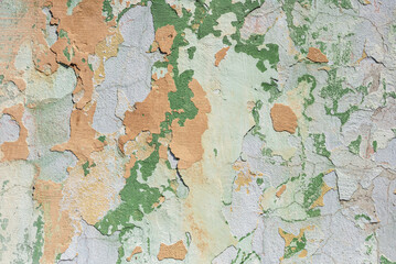 Peeled plaster on an old wall, background.