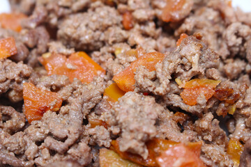ground beef texture. details of ready-to-eat ground beef. ground meat prepared with tomato. beef with selective focus.