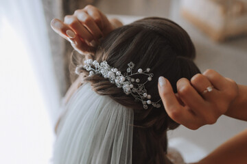 Textured wedding hairstyle with shiny hair accessories. Preparation for the wedding day