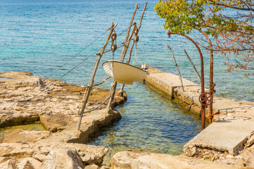 Fototapeta premium Savudrija, Adriatic Sea, Adriatic sea coast, Old fishing boat on chains. Seascape in summer.