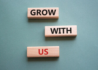 Grow with us symbol. Wooden blocks with words Grow with us. Beautiful grey green background. Business and Grow with us concept. Copy space.