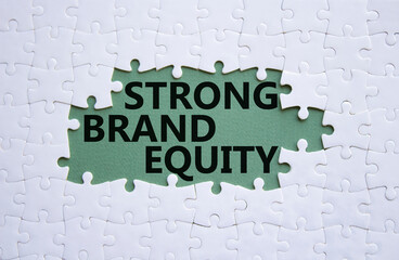 Strong Brand Equity symbol. Concept words Strong Brand Equity on white puzzle. Beautiful grey green background. Business and Strong Brand Equity concept. Copy space