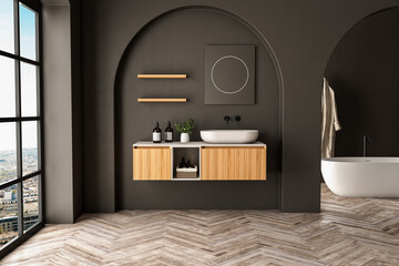Modern bathroom interior with wooden vanity, bathtub, parquet floor, black walls, arches, plants