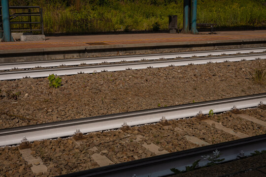 White painted railway or train tracks due to smaller heating of the track in the sun on the station of vipiteno, italy.