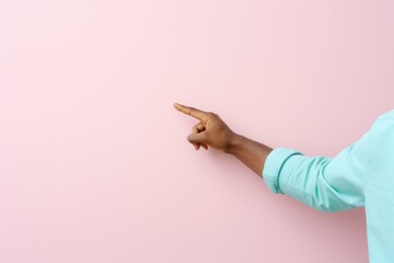 A black hand pointing finger to the left. Isolated on a plain colored pink background. Generative AI.