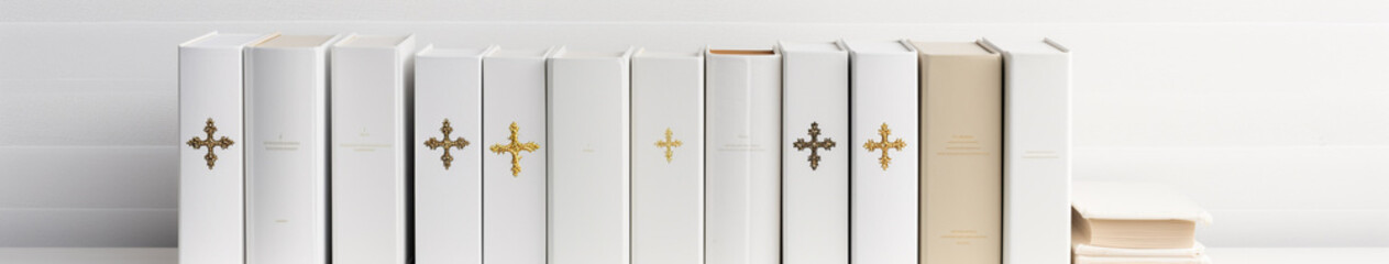 Christian religious background, banner. Books with a cross on the cover, bibles on a white wall background