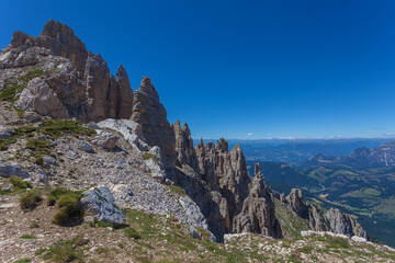 Panoramic view of famous Dolomites mountain peaks. Sharp spiers of Latemar norhern side, South Tyrol, Italy. Awesome mountain panorama