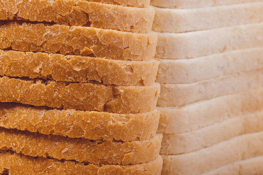 Sliced white bread with brown crust closeup.