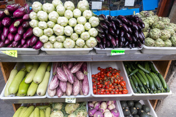 Various vegetables - zucchini, eggplant, tomato, chinese cabbage on the counter for sale in the...
