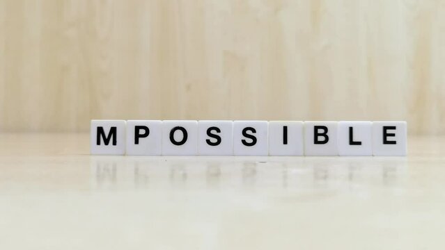 tiles that make up the word possible are modified to make up the word impossible