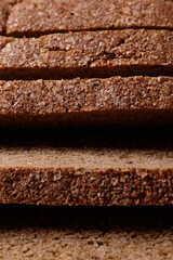 Sliced brown bread covered with bran closeup. Macro shot.
