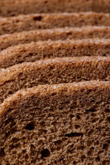 Sliced brown bread covered with bran closeup. Macro shot.
