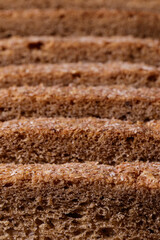 Sliced brown bread covered with bran closeup. Macro shot.
