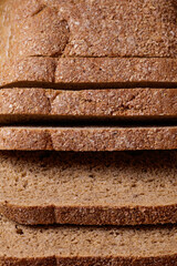 Sliced brown bread covered with bran closeup. Macro shot.
