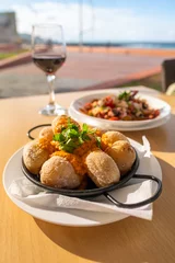 Fototapete Kanarische Inseln Canary Islands dish Papas Arrugadas wrinkly salty potatoes with and Mojo picon red spicy sauce.