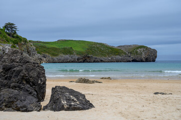 Naklejka premium View on Playa de Borizo in Celorio, Green coast of Asturias, North Spain with sandy beaches, cliffs, hidden caves, green fields and mountains.