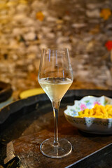 Tasting of grand cru sparkling white wine with bubbles champagne by old champagne caves in grand cru wine producer small village Cramant, Champagne, France