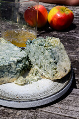 Cabrales blue cow's milk cheese and apple cider made by rural farmers in Asturias, Spain, Las Arenas in Picos de Europa on old wooden table