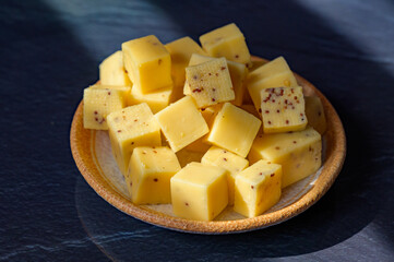 Cheese collection, matured yellow cow cheese with mustard seeds from Belgium