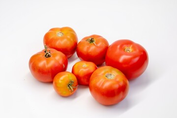Fresh tomatoes on a white background. Red bright tomatoes, healthy vegetarian food.