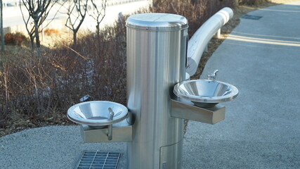 Metal drinking fountain in winter park
