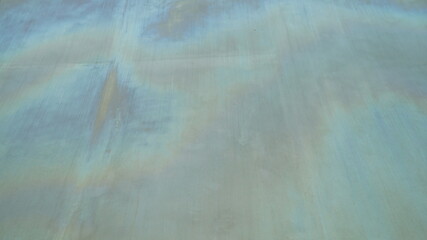 The surface of an old, faded metal building