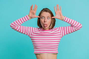 Funny comical playful young woman making silly facial expressions and grimacing, fooling around,...