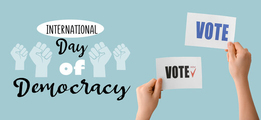 Banner for International Day of Democracy with female hands holding ballots
