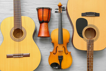 Different musical instruments on wooden background