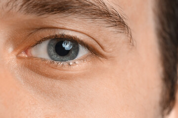 Fototapeta na wymiar Young man with blue eyes, closeup