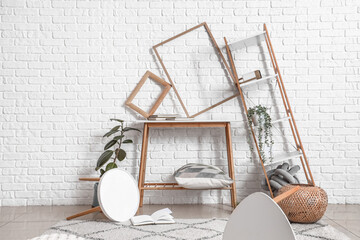 Tables with frames and shelving unit in messy living room