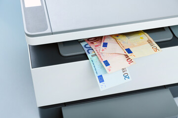 Laser printer with euro banknotes on light background, closeup