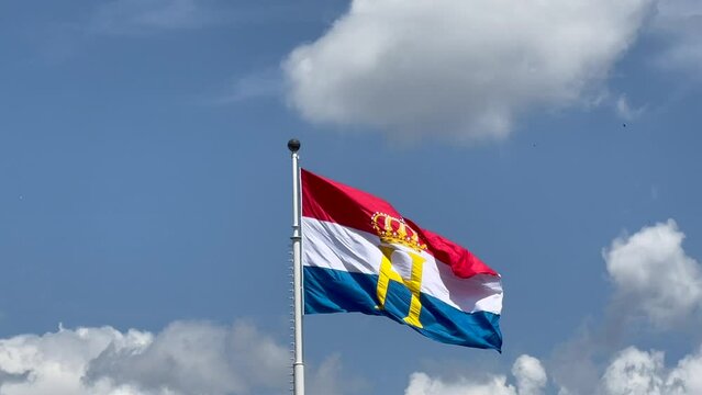 Luxembourg flag with monogram H and crown, flown to celebrate National day and Grand Duke's Henry official birthday. Luxembourg, Luxembourg - June 23, 2022