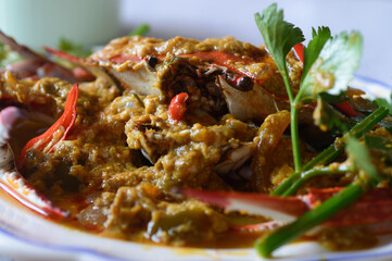 Crab curry stir fry or pu pad pong garee is a classic Thai dish. Crab is stir fried in savory egg custard sauce.