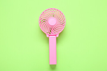Modern manual fan on green background