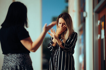 Woman Crying Fighting with Her Best Friend Outdoors. Unhappy emotional girl disagreeing with her...